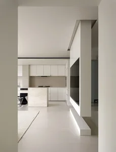 Modern kitchen with white marble island and white cabinets