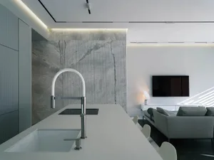 Modern living room and kitchen with white marble flooring, minimalist design, and open layout.