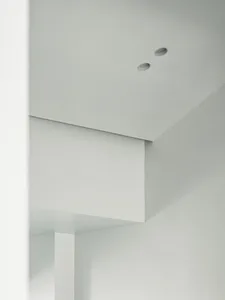 A minimalist interior design with white walls and a clean, uncluttered space.
