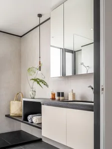 A modern bathroom featuring a gray concrete countertop and minimalist design elements.