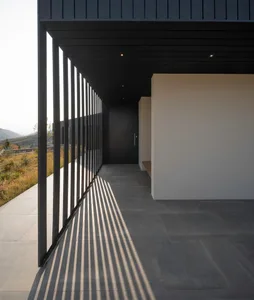 Modern entrance with concrete bar and minimalist design.