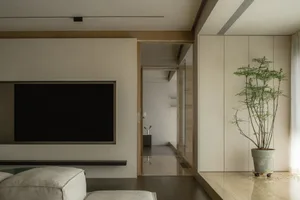 Modern living room featuring sleek, minimalist design with concrete, wood, and metal elements.