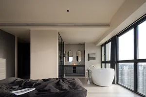 Modern residential interior with a bathtub and a view of the city.