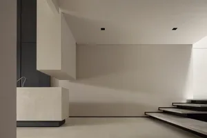 A minimalist, contemporary stairwell with a concrete finish and clean lines.