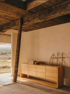 Minimalist living room designed in wood with a natural color palette.