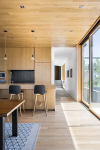 A modern kitchen with wooden cabinets and metal accents.