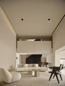 A minimalist living room with a white, textured-cotton sofa and a modern, sleek coffee table.