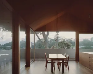 Modern minimalist dining room featuring wood elements.