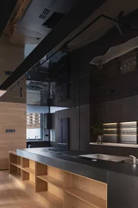 Modern kitchen featuring concrete countertops and wooden cabinets.