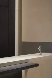 Modern minimalist bathroom featuring a sleek marble counter with a simple faucet.