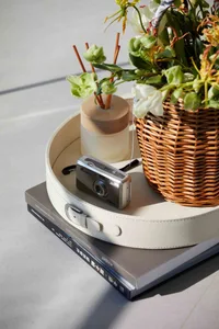 Wicker rattan decorative objects placed on a tray.