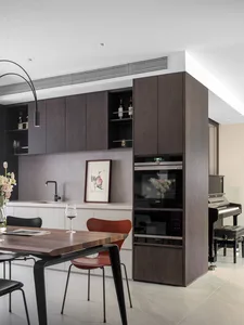 Modern kitchen featuring wooden cabinets and metal frame furniture, with a focus on sleek, minimalist design.