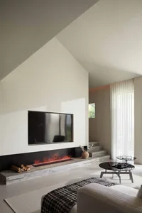 A minimalist modern living room with a white interior and fireplace, featuring elegant furniture and a simple, well-lit desig