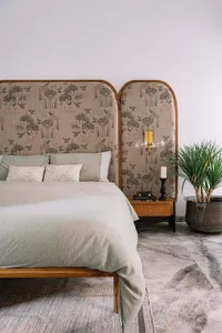 Modern bedroom featuring a bed with marble, fabric, and wood elements