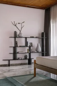 A minimalist bedroom featuring a wooden bed, marble floor, and cotton bedding.