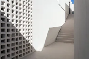 A minimalist concrete staircase rendered in 3D, featuring clean lines and geometric shapes.