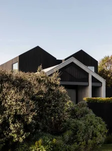 A modern house featuring a combination of concrete and wood materials.