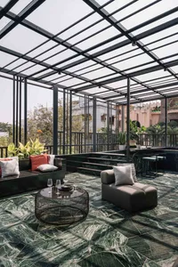 Industrial-style rooftop deck featuring exposed wood and a glass canopy.