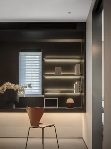 A modern minimalist office space with wooden shelves and a sleek design