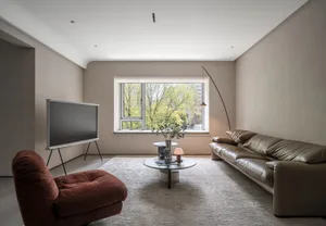 Contemporary minimalist living room with modern furniture and neutral color palette.