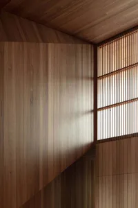 A modern minimalist interior featuring wooden paneled walls
