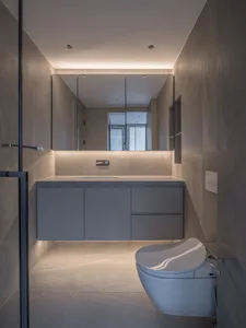 Modern minimalist bathroom with ceramic fixtures and sleek design.
