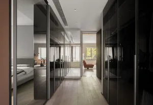 Modern residential interior featuring glass doors and wooden flooring.