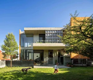 A modern residential home with concrete and glass features.