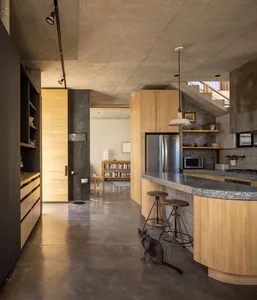Industrial-style kitchen with concrete finishes and wooden elements.