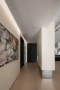 Modern minimalist corridor with lighting along the ceiling and walls.
