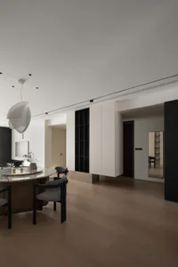 A minimalist indoor space featuring wooden flooring and furniture