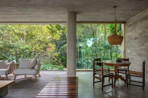 Concreted walls and wooden furniture in a modern residential living room.