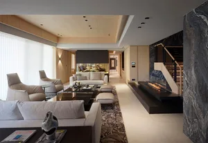 Photograph of a modern living room featuring a marble floor, a white sofa, and a stone fireplace.
