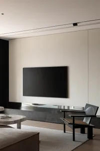 Modern minimalist living room featuring marble, metal, and wood elements.