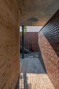 A modern architectural space featuring brick and concrete materials.