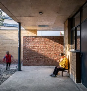 A modern interior space featuring brick and concrete materials.