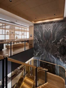 Modern residential sitting room featuring marble accents and wooden elements.