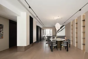 Modern living and dining area with wooden flooring, marble countertops, and metallic accents