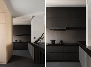 Modern kitchen featuring black marble countertops and wooden cabinets.