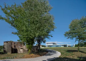 Modern residential home with large glass walls and concrete structural elements