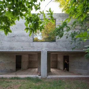 Concrete interior space with a large window and natural light.
