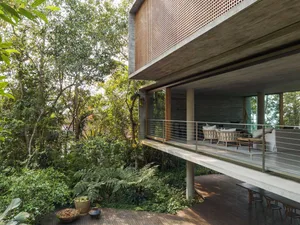 A modern residential building with a combination of concrete and wood materials.