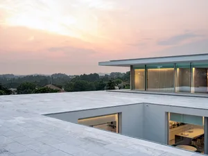 Exterior view of a modern residential living space showcasing contemporary architectural features made of concrete and glass.