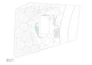 A detailed architectural floor plan depicting a residential home with surrounding vegetation, rock formations, and concrete s