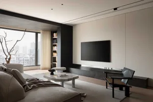 Modern living room with minimalist design, marble accents, black furniture, and large windows showing cityscape.