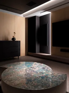 A modern living room with a round marble coffee table and minimalist interior design.
