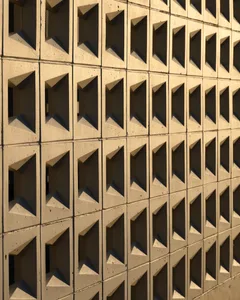 Modern architectural pattern made of concrete blocks with geometric shapes.