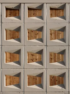 Modern architectural design featuring concrete blocks arranged in a geometric pattern.