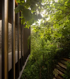 A modern exterior featuring wooden, stone, and metal elements.