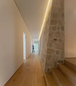 Modern interior design featuring stone and wooden elements.